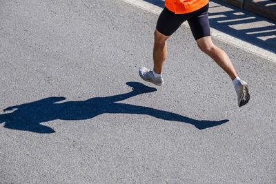 Low section of woman walking on road