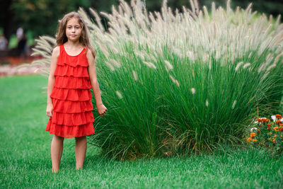 Portrait of girl standing on grass