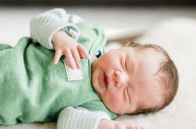 Close-up of newborn baby boy sleeping at home