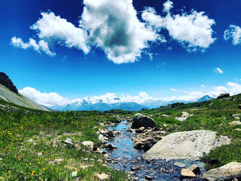 Scenic view of mountains against blue sky