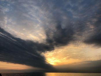 Low angle view of dramatic sky over sea during sunset
