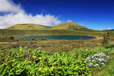 Scenic view of mountains against blue sky