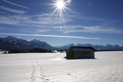 Built structure on snow covered land against sky