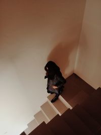 High angle view of woman standing against wall