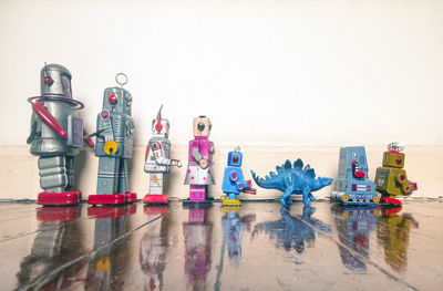 Row of toys on floor against white background