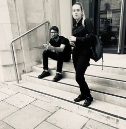 Portrait of young couple sitting on staircase