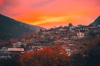 High angle view of townscape against orange sky