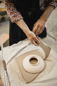 Midsection of man working on table