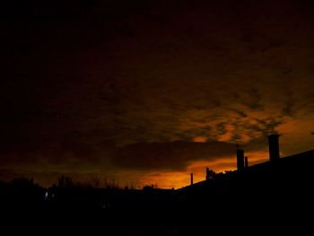 Silhouette of building against sky at sunset