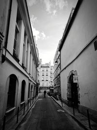 Street amidst city against sky