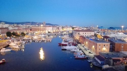 High angle view of illuminated harbor against clear blue sky