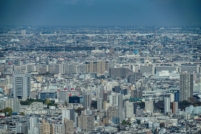 High angle view of modern buildings in city against sky