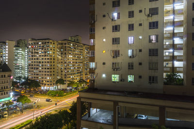 Illuminated buildings in city against sky at night