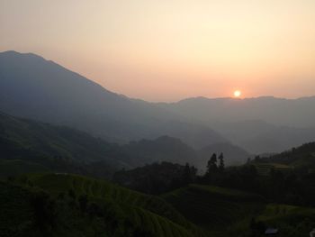 Scenic view of mountains against sky during sunset