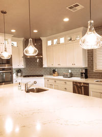 Illuminated electric lamp on table at home