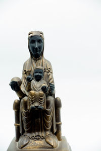Low angle view of buddha statue against clear sky