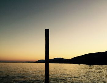 Scenic view of lake against sky at sunset