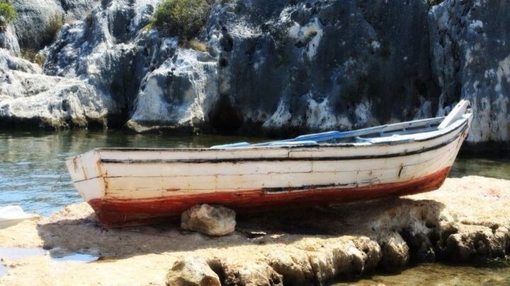 nautical vessel, water, boat, moored, transportation, mode of transport, beach, sea, shore, rock - object, tranquility, nature, lake, tranquil scene, wood - material, sand, mountain, day, outdoors, beauty in nature