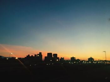 Silhouette of city at sunset