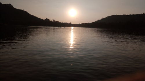 Scenic view of lake against sky during sunset