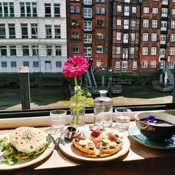 Flower vase on table by window in building