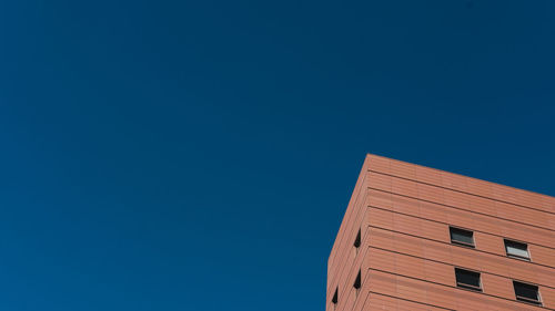 Low angle view of building against blue sky
