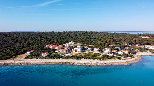 Scenic view of sea and buildings against sky