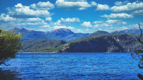 Scenic view of sea and mountains against sky