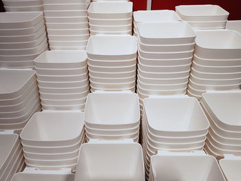 Full frame background of group of stacked white plastic containers