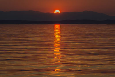 Scenic view of sea against romantic sky at sunset