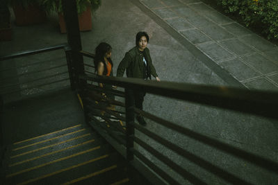 Rear view of woman walking on steps