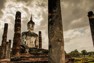 Low angle view of statue against buildings