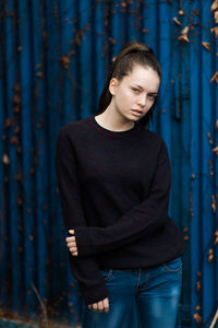 Portrait of young woman standing outdoors