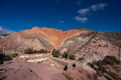 Scenic view of mountain against blue sky