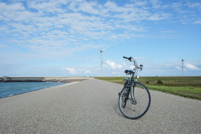 Windturbines view in holland with elegant green bike at front