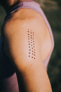 Close-up of woman with tattoo