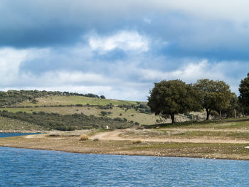 Scenic view of river and landscape against sky