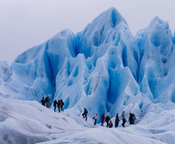 Group of people on snow covered landscape