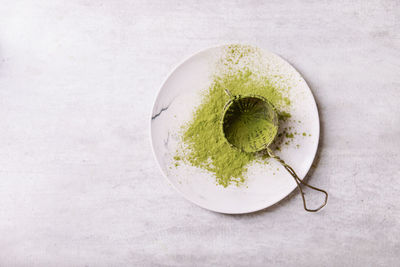 High angle view of fruit in plate against white background