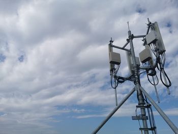 Low angle view of telephone pole against sky