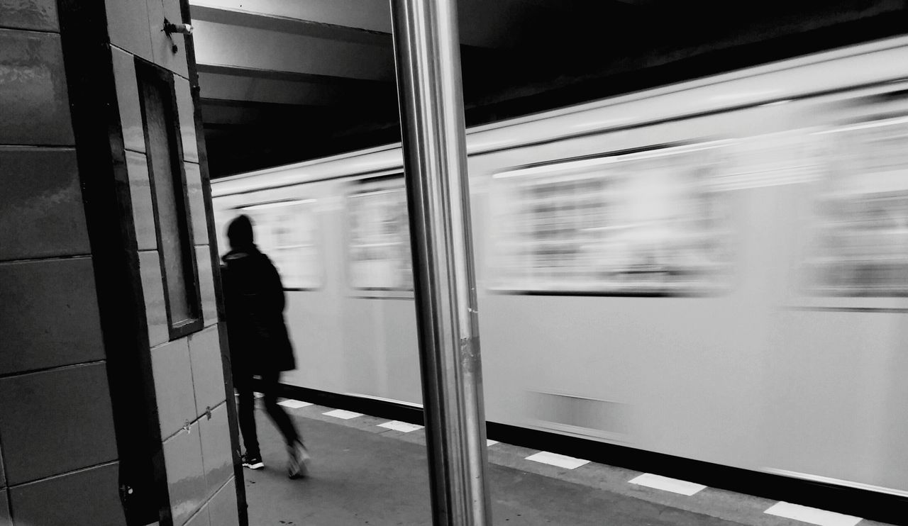 indoors, men, lifestyles, rear view, window, full length, person, walking, standing, glass - material, leisure activity, reflection, silhouette, transparent, transportation, unrecognizable person, railing