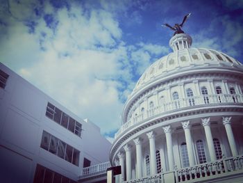 Low angle view of building against cloudy sky