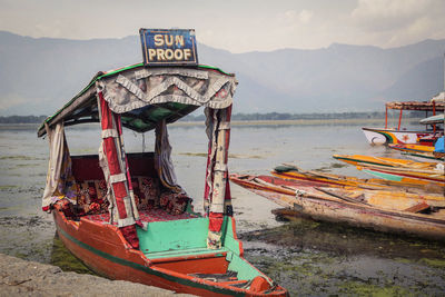 Boats in sea with mountain range in background