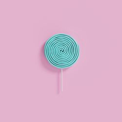 Close-up of multi colored candies against pink background