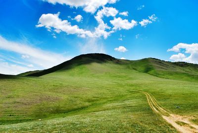 Scenic view of landscape against cloudy sky