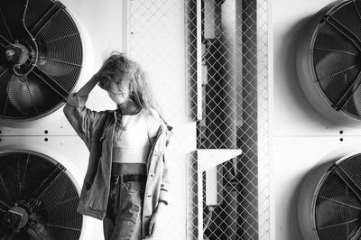 Rear view of woman standing in bathroom