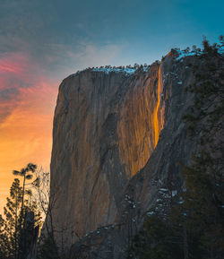 Low angle view of rock formation against sky during sunset