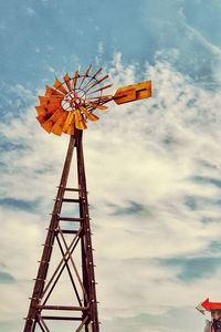 Low angle view of traditional windmill against sky