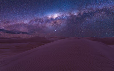 Scenic view of desert against sky at night