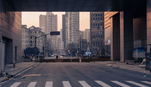 City street and buildings against sky